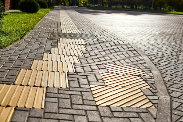 Yellow tactile paving on walkway, tactile ground surface indicators for blind and visually impaired